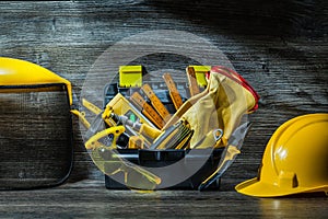 Construction tools in little tollbox on table