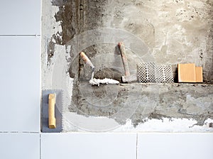 Construction tools notched trowel and hammer