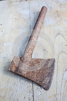 Construction tools,Old rusty axe on the wood table