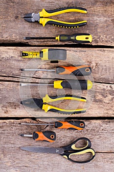 Construction tools set on old wooden background.