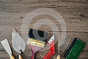 Construction tools on wooden background.  Set of assorted plaster trowel tools and spatula . Copy space for text