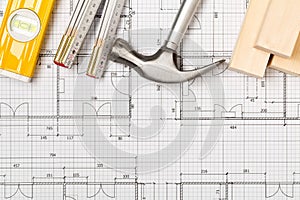 Construction tools and wooden strips on architectural blueprint house building plan with copy space