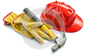 Construction tools yellow leather gloves red helmet and hammer iswolated on white