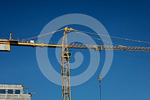 construction tower crane against blue sky