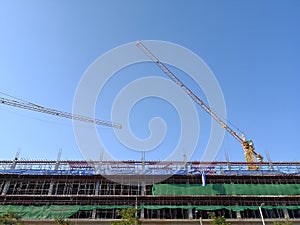 Construction tower crane working at new building site