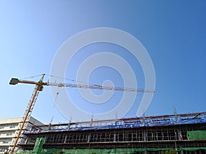 Construction tower crane working at new building site