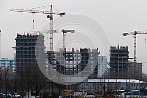 Construction with tower cranes in Moscow in everning
