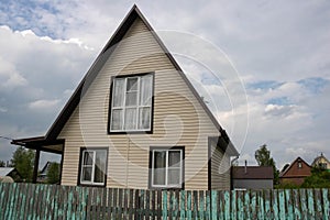 Construction of a traditional Russian wooden dacha under a cloudy sky