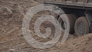 A construction truck stalled in the sand. Center differential lock, background, industry. Wheel grip