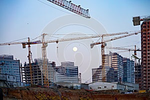 Construction under construction, crane and full moon