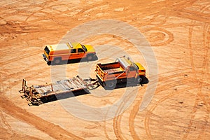 Construction vehicles and car traces in dust clay