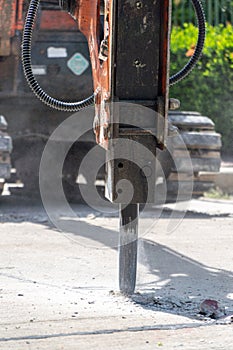 Construction Vehicles repairing road. drilled into the driveway surface with jackhammer