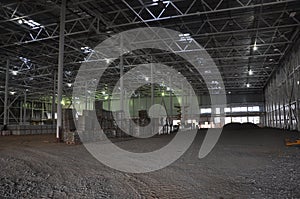 Construction of a warehouse complex, inside view. Columns are installed, crushed stone is laid on the floor