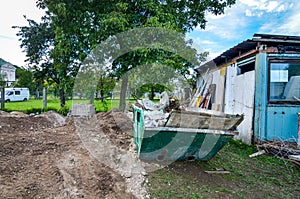 Construction waste container dumpster at residential house construction site.