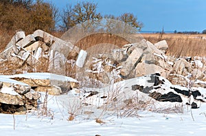 Construction waste in the field, the wreckage of concrete slabs in nature