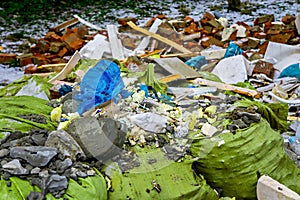 Construction waste lies on the grass and snow photo