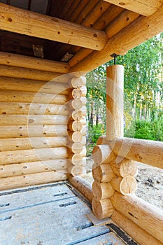 Construction of wooden house made of natural logs