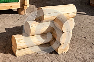 Construction of the wooden house from round logs. Blockhouse logs example, element in store. Corner connection of wooden log house