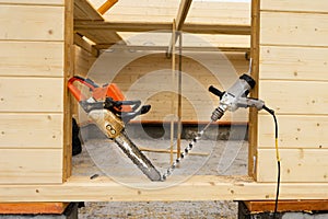 When construction a wooden house, two chainsaws a bit