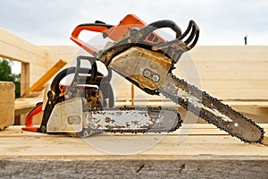 When construction a wooden house, two chainsaws a bit