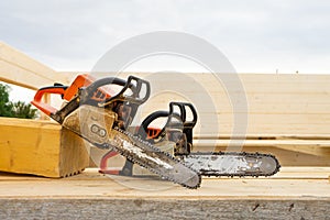 When construction a wooden house, two chainsaws a bit