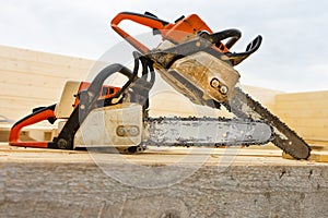 When construction a wooden house, two chainsaws a bit