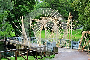 Construction of a wooden structure on a park bridge for an event with night lights and fireworks