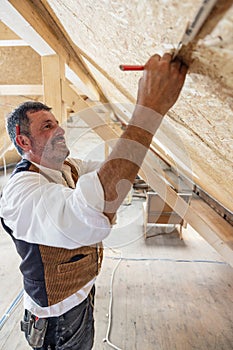 Construction woodworker measuring on site