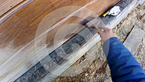 Construction work with a brush in a house built of wood