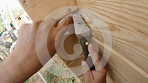 Construction work with a brush in a house built of wood