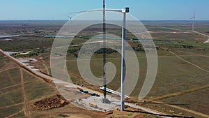 Construction work on a huge wind turbine, crane next to it, green energy, 4k