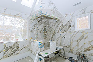 Construction work installing ceramic tile on reconstruction of bathroom