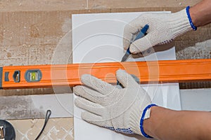 Construction work laying tile on the wall