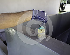 Man using a brush to paint a swimming pool photo