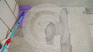 Construction work  plastering and wall priming. Builder's hand with paint roller.