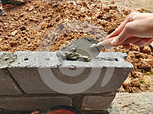 Construction work by putting bricks together and plastering the walls requires expertise