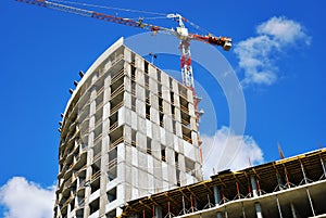 Construction work site with crane on blue sky