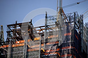 Construction work site residential lots of tower construction site with cranes and building with blue sky