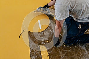 A construction worker apply epoxy resin in an industrial deposit