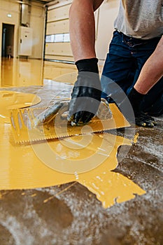 A construction worker apply epoxy resin in an industrial deposit