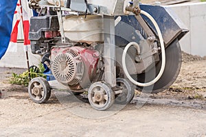 Construction worker with asphalt cutting machine