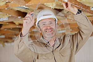 Construction worker assemble suspended ceiling