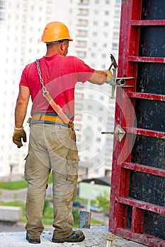 Construction worker assembling cement formwork