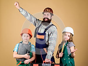Construction worker assistant. Builder or carpenter. Bearded man with little girls. Repair. Childrens creativity