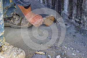 Construction Worker with broom sweeping concrete 2