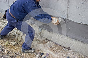 Construction worker with brush applied hydro insulation 2