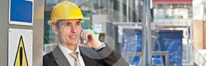 Construction Worker Builder on Building Site Talking on Phone Panorama