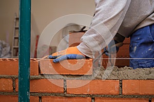 Construction worker building a brick wall