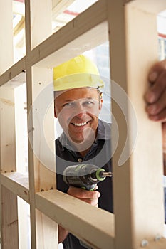 Construction Worker Building Timber Frame In New H