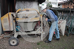 Construction worker with cement mixer